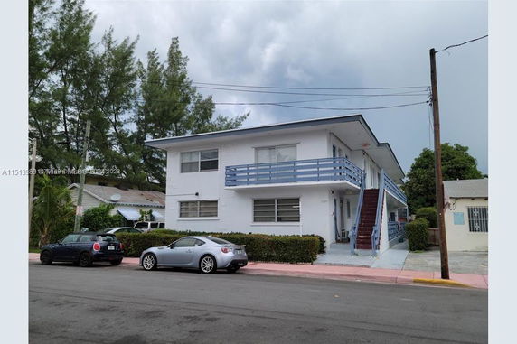 Front view of a two-story apartment building with external stairs.