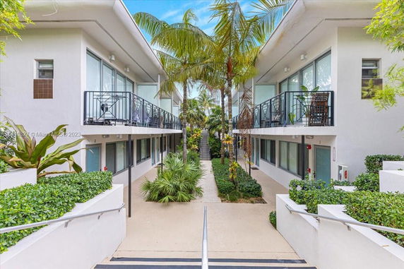 Front view of a modern two-story apartment complex with balconies.