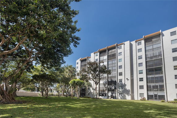 Front view of a multi-story apartment building with balconies.
