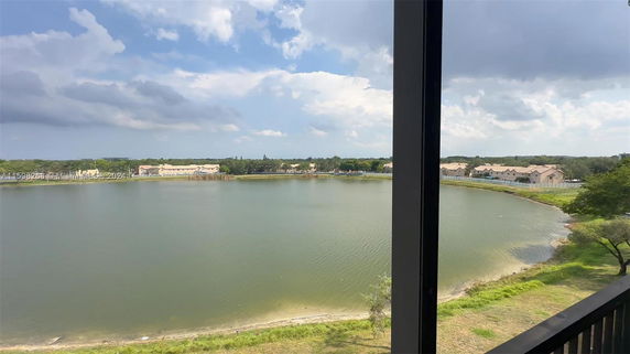 Panoramic view of a lake with houses in the background.