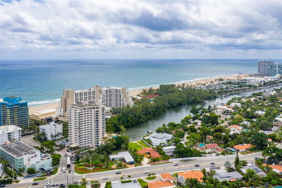 Aerial view of a coastal cityscape with buildings and ocean in the background.