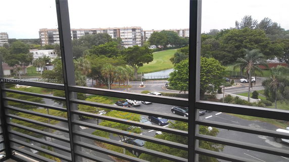 View from a building showing surrounding residential buildings and green landscape.