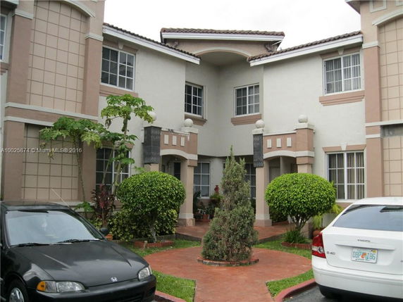 Front view of a two-story townhouse with decorative details.