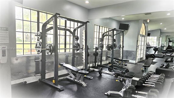 Interior view of a fitness gym with weightlifting equipment.