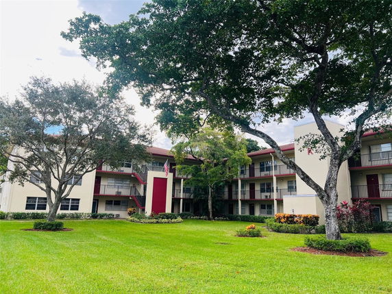 Front view of a multi-story residential building with balconies.