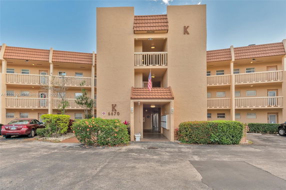 Front view of a multi-story residential building with balconies.