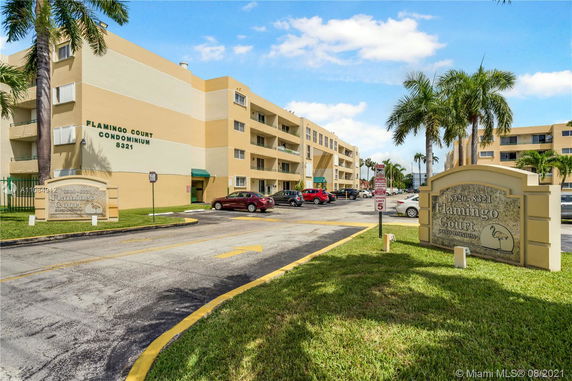 Front view of a multi-story condominium building with balconies.