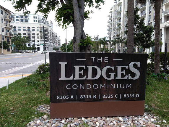Front view of a multi-story condominium building with balconies.