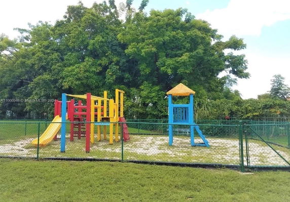 Colorful children's playground with slides and climbing structures.