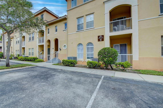 Front view of a multi-story residential building with balconies.