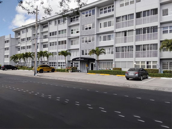 Front view of a multi-story residential building with balconies.