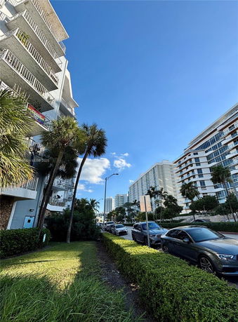 Side view of a multi-story residential building with balconies.