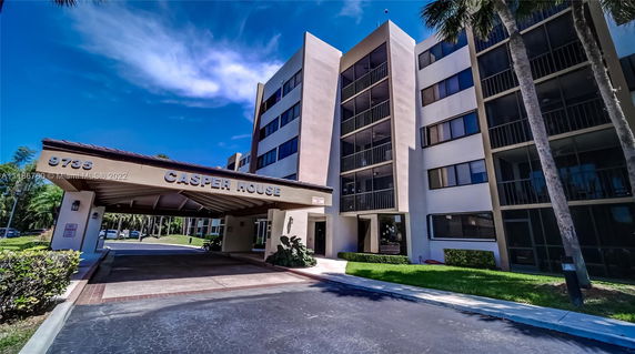 Front view of a multi-story building with a covered entrance.