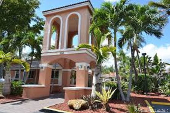 Front view of a house with arched openings and a terracotta finish.