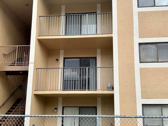 Front view of a multi-story building with balconies.