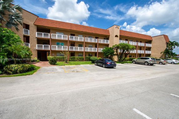 Front view of a three-story building with balconies.