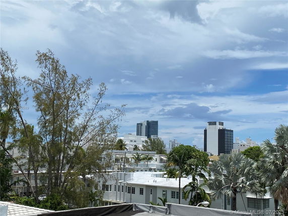 Panoramic view of urban landscape with multiple buildings and trees.
