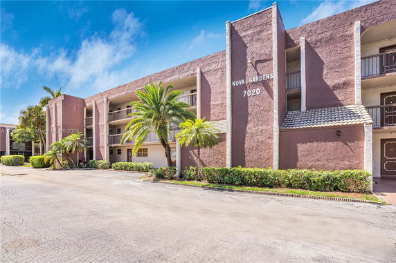 Front view of a multi-story residential building with balconies.