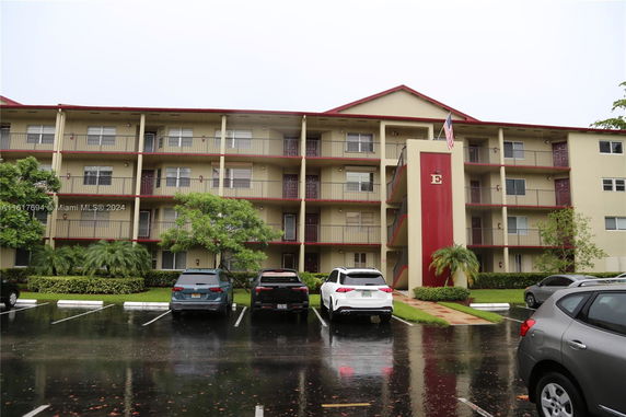 Front view of a multi-story apartment building with balconies.