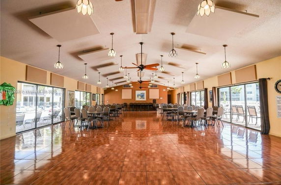 Spacious indoor area with tables and chairs set up for gatherings or events.