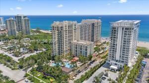Aerial view of multiple high-rise buildings near the ocean.