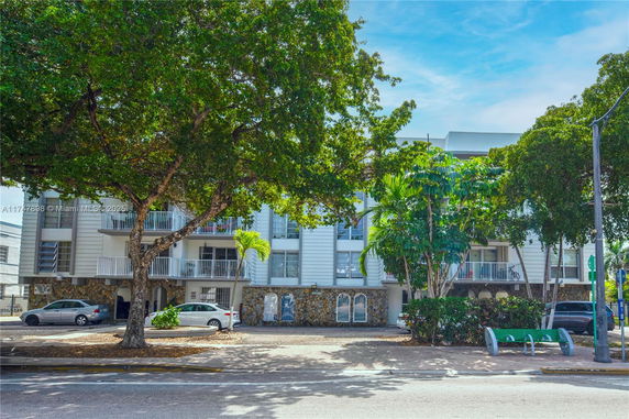 Front view of a multi-story residential building with balconies.