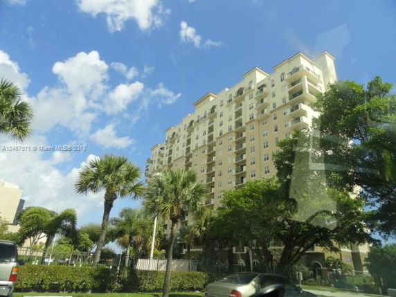 Front view of a multi-story residential building with balconies.