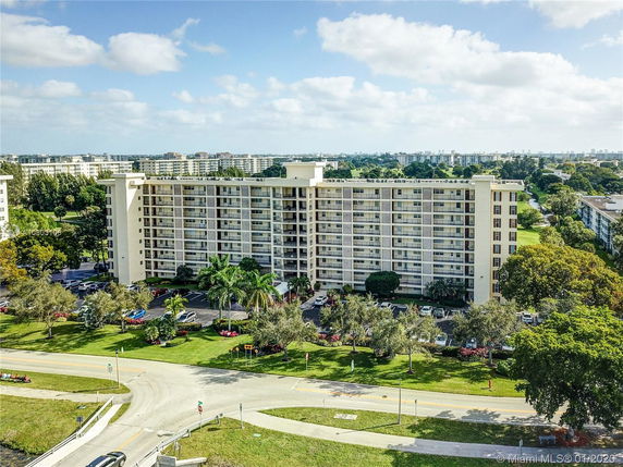 Front view of a multi-story residential building with balconies.