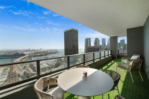 Balcony with city and waterfront view from a high-rise apartment.