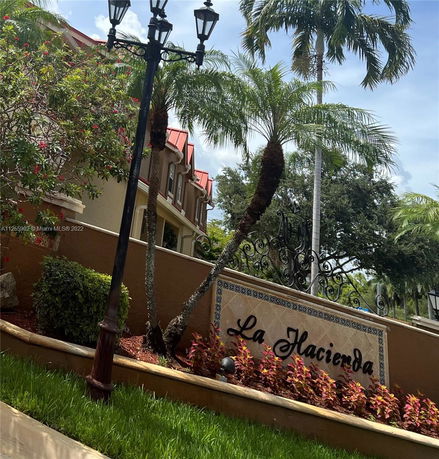Front view of a residential building with red roofs and decorative signage.