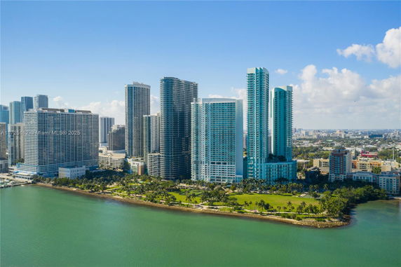 Aerial view of a cluster of high-rise buildings along the waterfront.