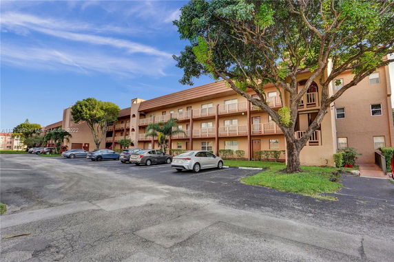 Front view of a multi-story residential building with balconies.