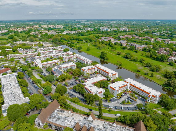 Aerial view of a residential complex with multiple buildings and surrounding greenery.