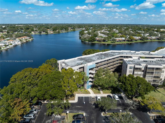 Aerial view of a multi-story building near a body of water.