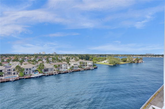 View of waterfront houses with docks along a canal.