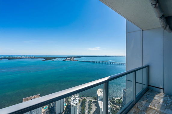 Balcony view of ocean and bridge from a high-rise building.