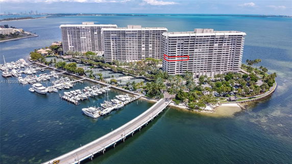 Aerial view of a waterfront residential complex with adjacent marina.