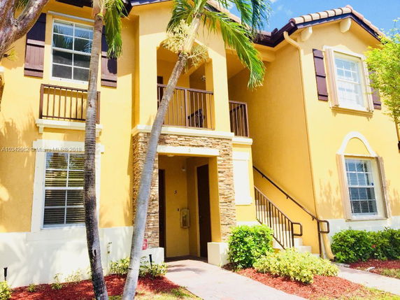 Front view of a two-story house with stone accents and shutters.