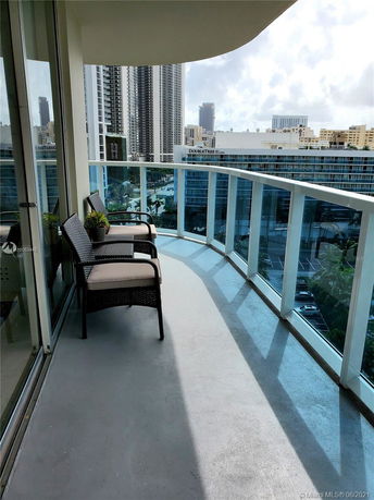 Balcony view showing surrounding high-rise buildings.