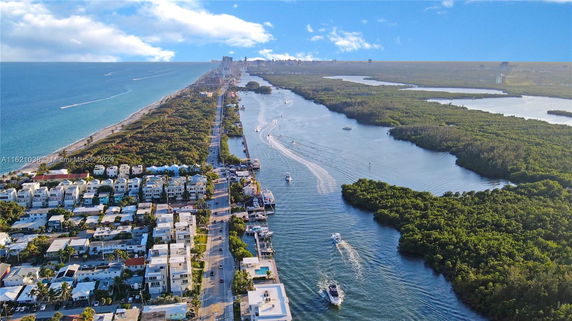 Aerial view of a coastal area with buildings and waterways.