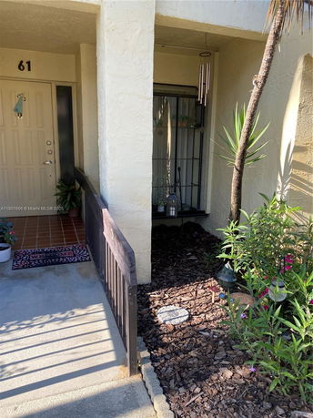 Entrance view of a house with a porch and a front door labeled 61.