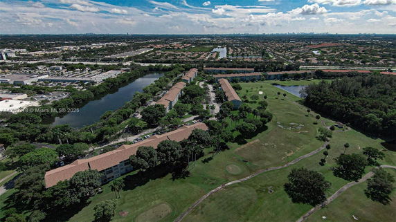 Panoramic view of a large residential area with surrounding greenery and water bodies.