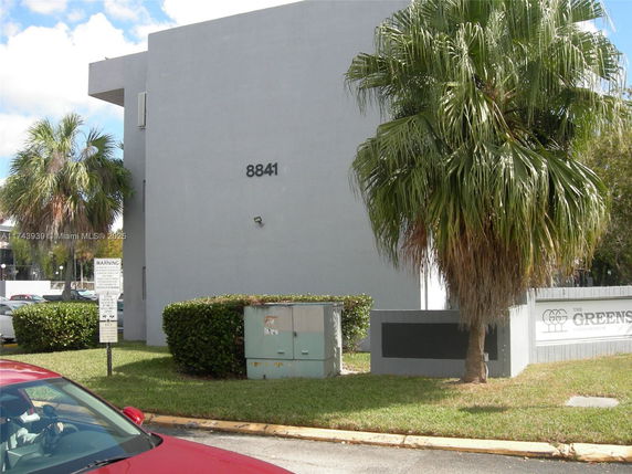 Side view of a large modern building with minimal architectural features.