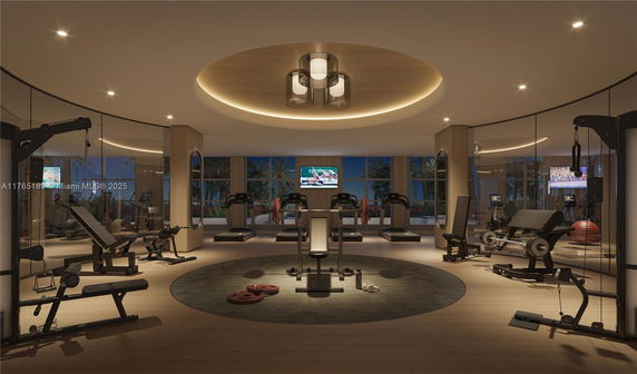 Interior view of a modern gym with various exercise equipment and a large circular ceiling light.