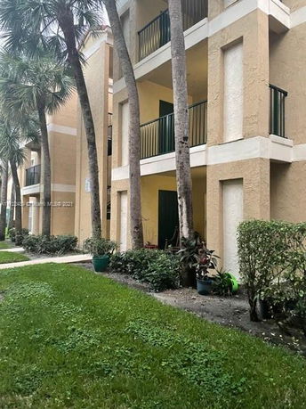 Front view of a multi-story apartment building with balconies.