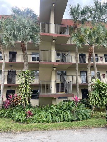 Front view of a multi-story building with balconies.