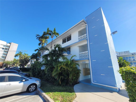 Front view of a three-story building with a blue facade.
