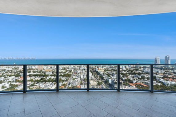 Wide view from a high-rise building showing a cityscape and ocean.