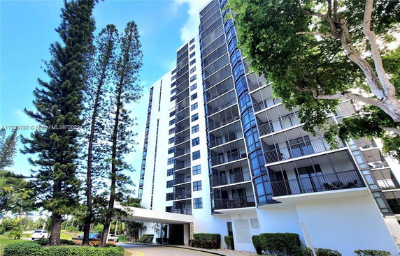 Front view of a multi-story residential building with balconies.