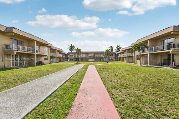 View of a residential complex with multiple two-story buildings and balconies.